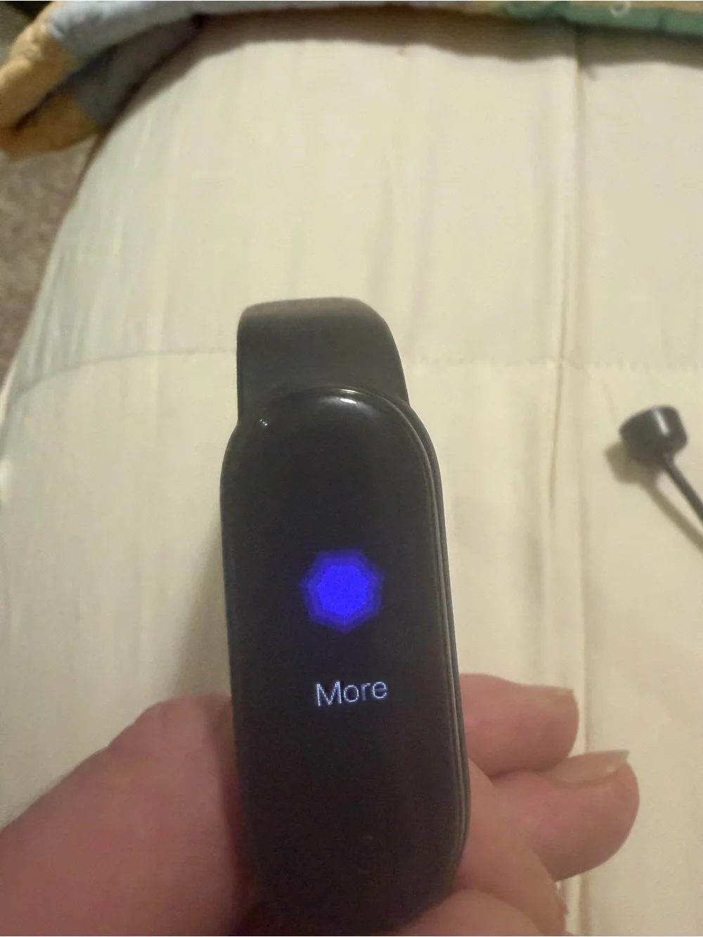 black Xiaomi Mi Band fitness tracker, model 6 or similar,